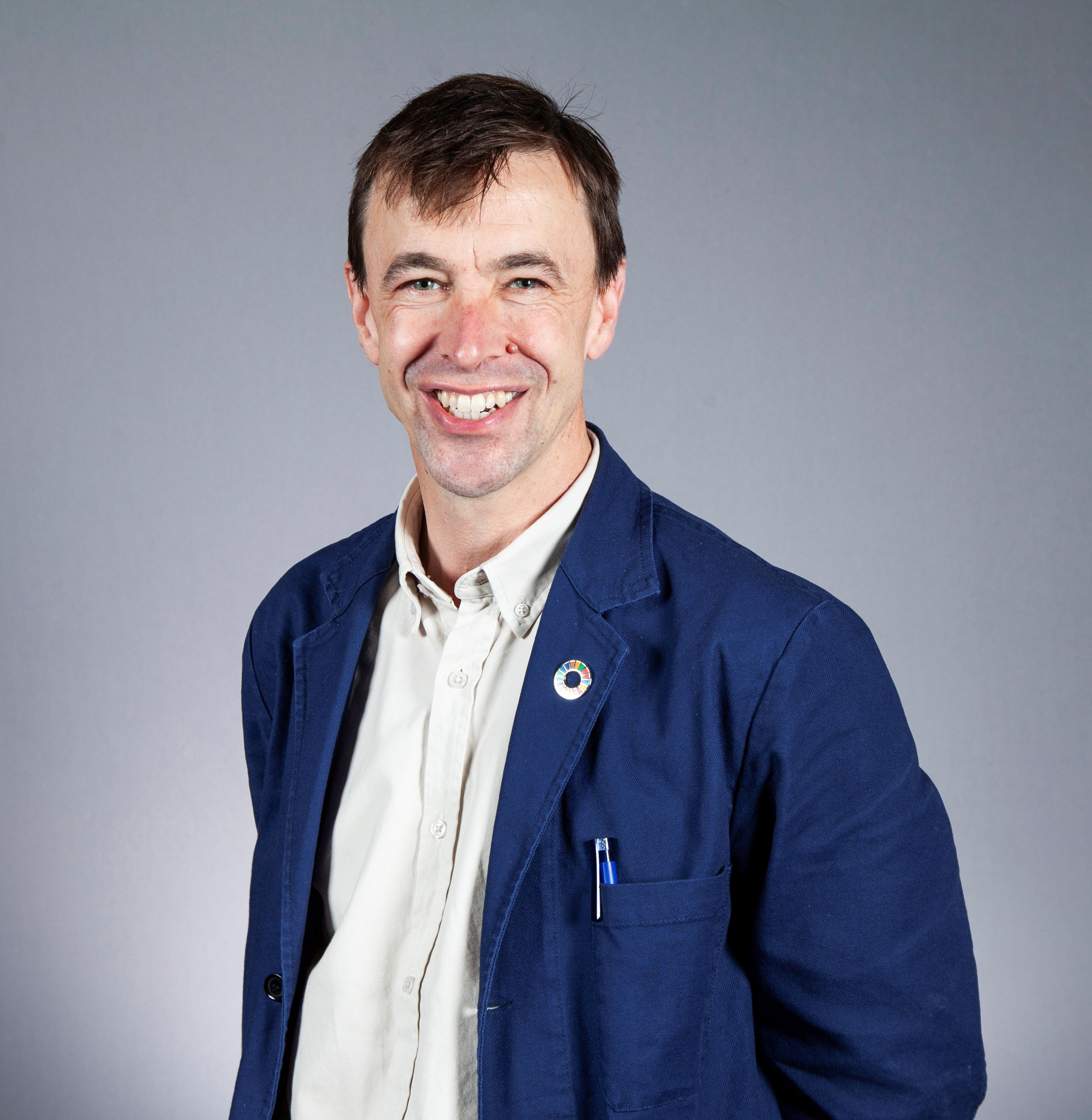 Rob Doubleday headshot wearing blue jacket