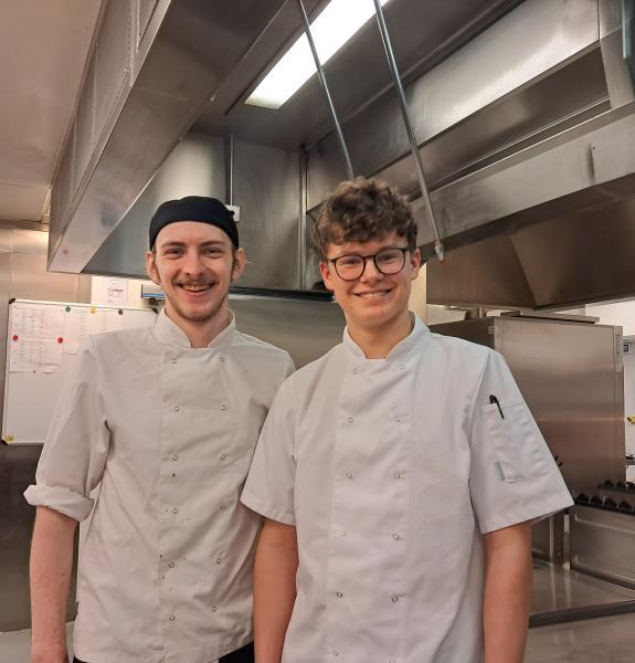 Two people in white chef's uniforms